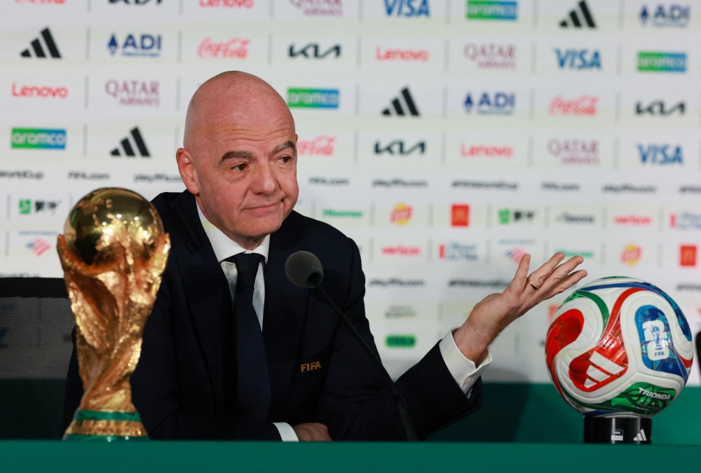  
FIFA President Gianni Infantino with the FIFA World Cup trophy during the press conference  
