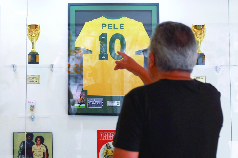 A visitor points to the jersey of Brazilian soccer legend Pele, which is part of an exhibition where the public can visit the room where Pele stayed ahead of the 1970 World Cup final, at the Inter-American Conference on Social Security (CISS) in Mexico City, Mexico June 2, 2026. REUTERS/Raquel Cunha