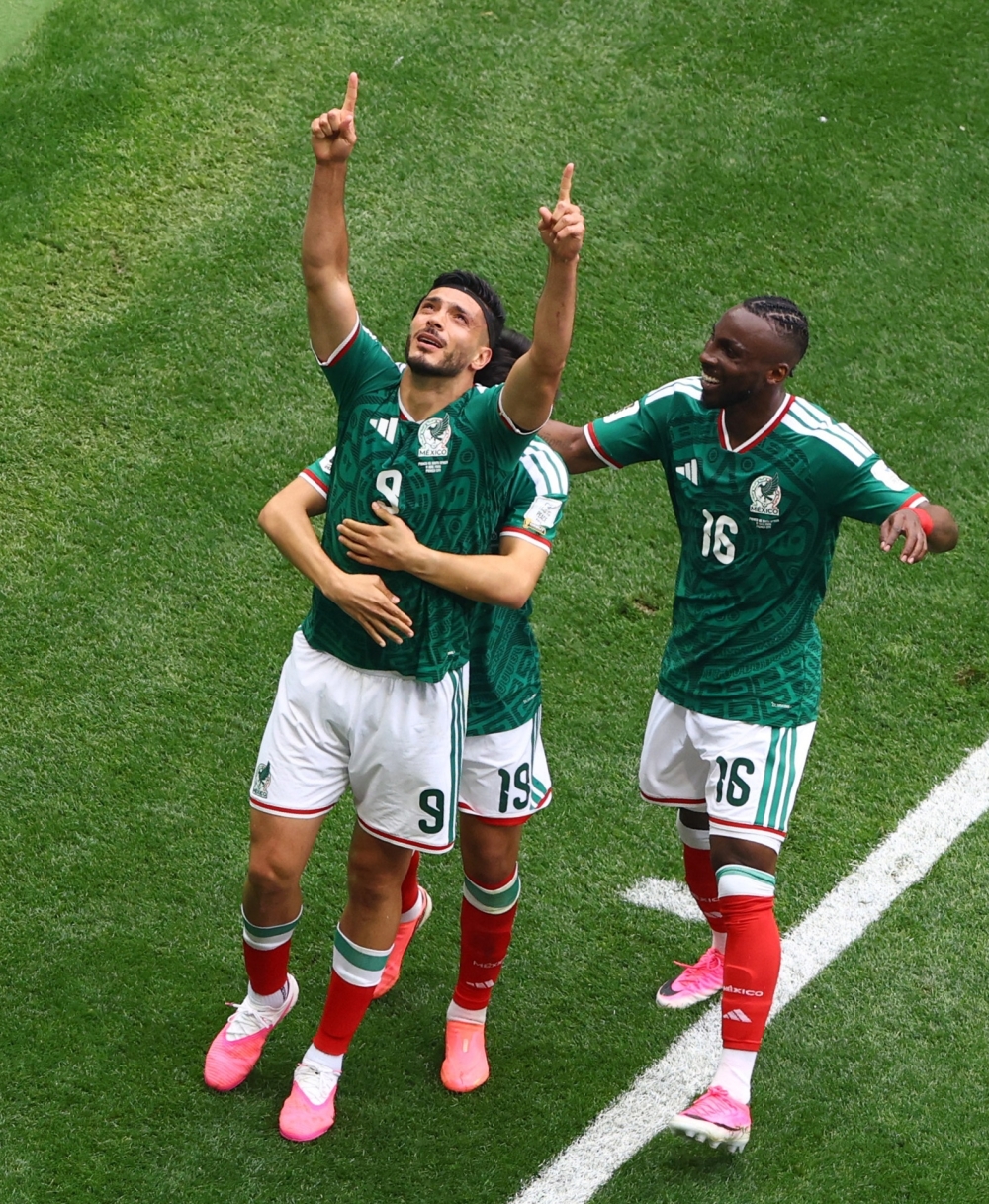 Mexico's Jimenez celebrates scoring their second goal with Gilberto and Quinones. — Reuters