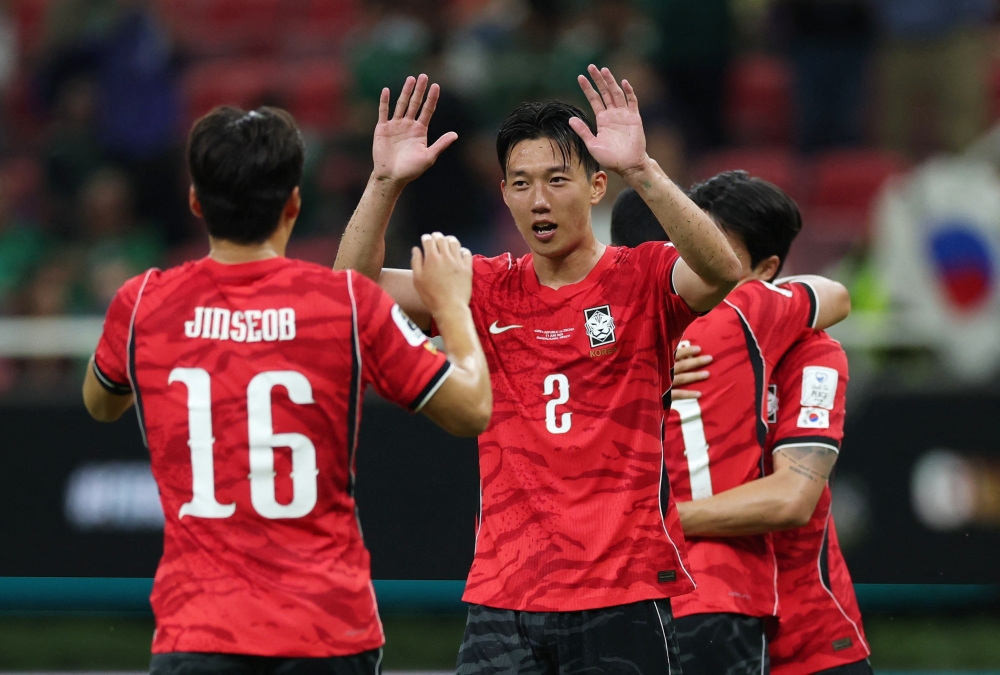 
South Korea's Lee Han-beom celebrates with Park Jin-seob after the match. — Reuters