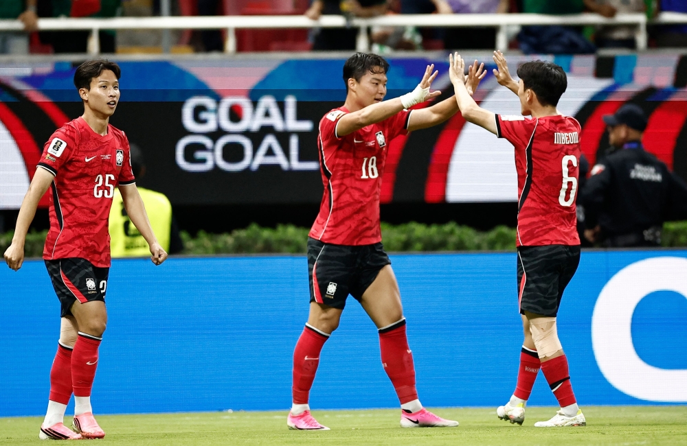 South Korea's forward Oh Hyeon-gyu celebrates with teammate Hwang In-beom scoring his team's second goal. — AFP