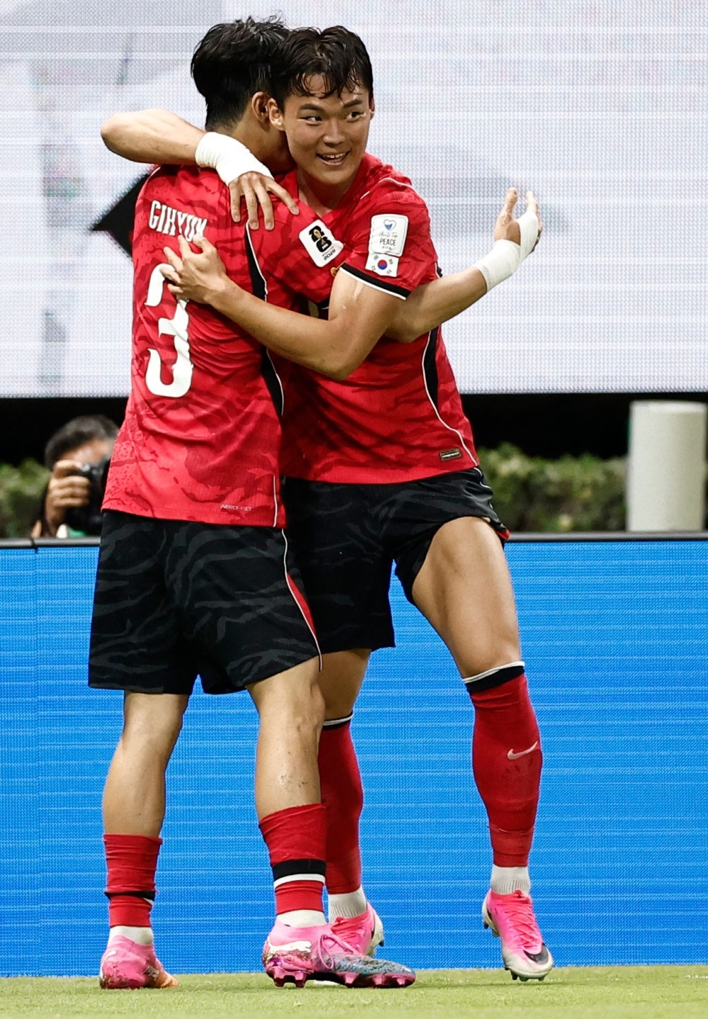 South Korea's forward #18 Oh Hyeon-gyu celebrates with teammate defender #03 Lee Gi-hyuk scoring his team's second. — AFP