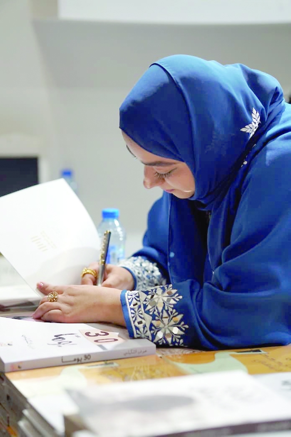 Lubna sign her book at the Muscat International Book Fair