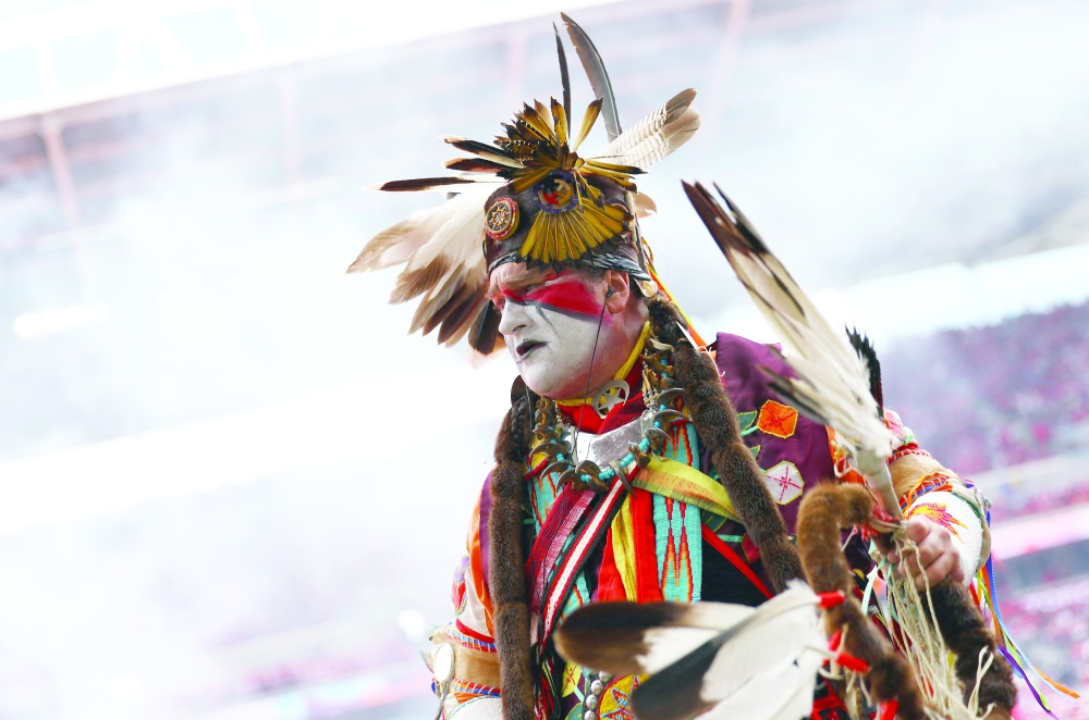 A performer during the opening ceremony before the match. — REUTERS