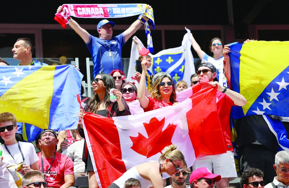 Canada and Bosnia and Herzegovina fans react during the opening ceremony. — REUTERS