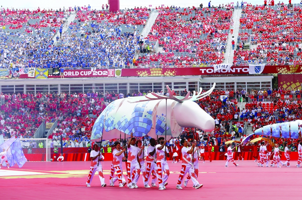 Performers on the pitch ahead of the match. — REUTERS