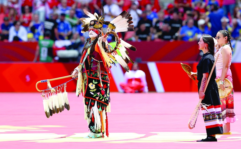 Performers on the pitch ahead of the match. — REUTERS