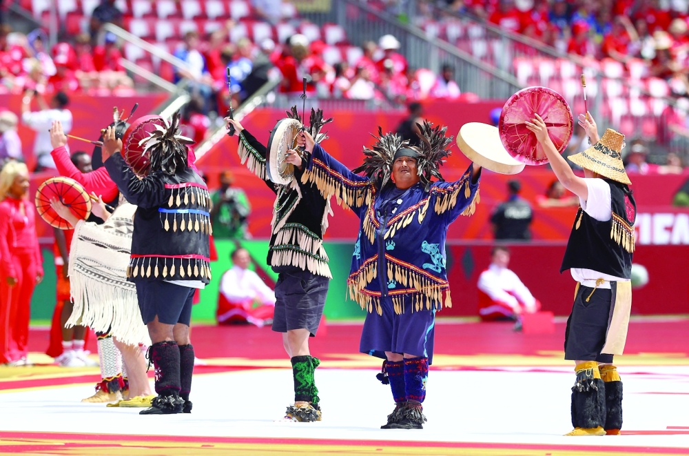 Performers on the pitch ahead of the match. — REUTERS