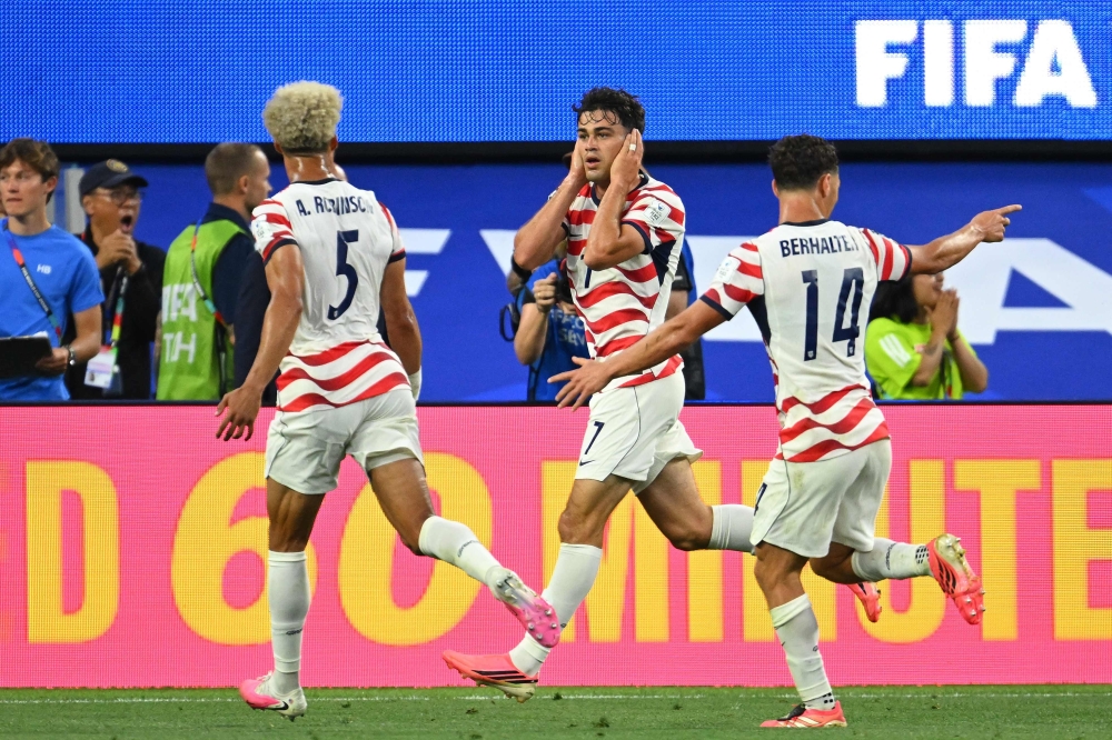 US midfielder #07 Giovanni Reyna (C) celebrates scoring his team's fourth goal. — AFP