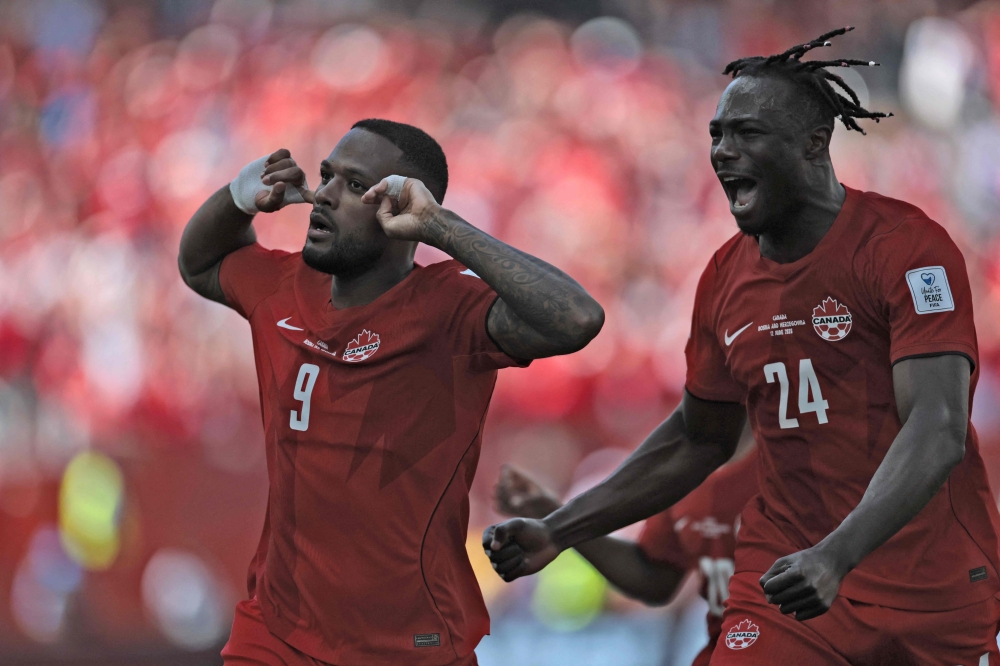 Canada's forward #09 Cyle Larin (L) celebrates after scoring a goal. — AFP
