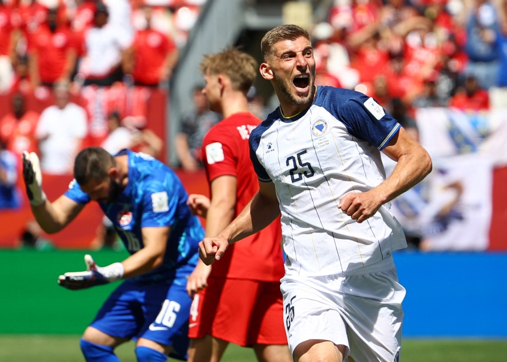 
Bosnia and Herzegovina's Jovo Lukic celebrates scoring their first goal. — Reuters