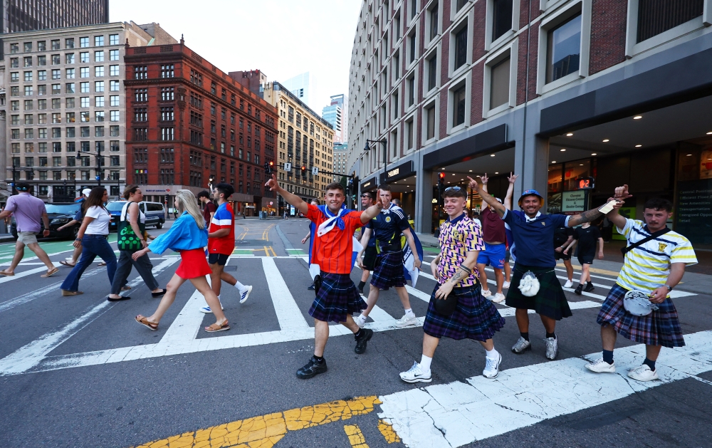 
Scotland fans wearing kilts walk across a street in Boston ahead of the match. — Reuters
