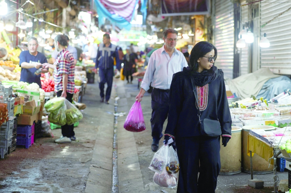 People walk in a local market in Tehran, Iran. — AFP