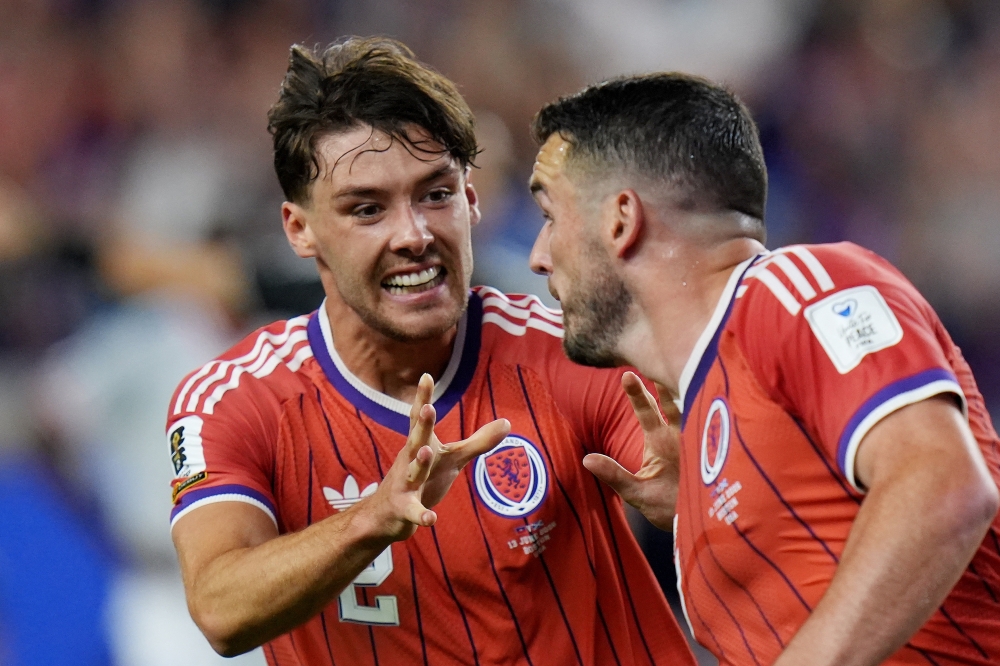  
Scotland's John McGinn celebrates scoring their first goal with Aaron Hickey. — Reuters