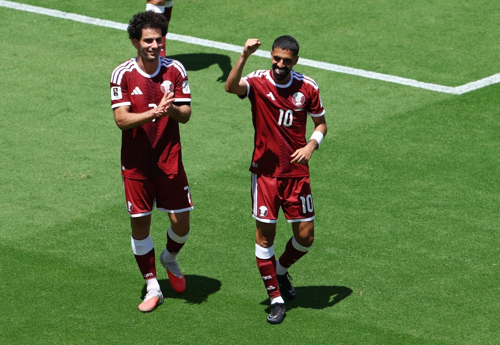 
Qatar's Ahmed Alaaeldin and Hassan Alhaydos celebrate after the match. — Reuters