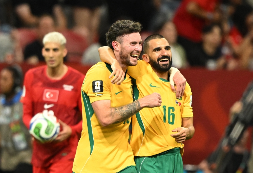 
Australia's Aiden O'Neill and Aziz Behich celebrate after the match. — Reuters