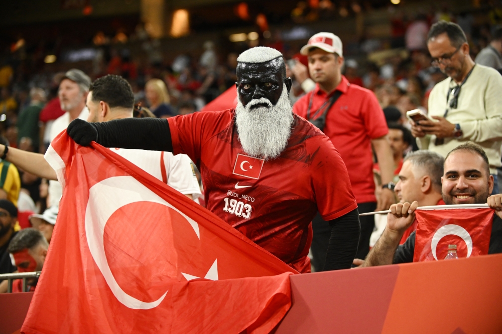 Turkey fans in the stands pose for a photograph. —  Reuters