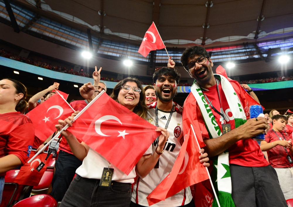 Turkey fans in the stands as they pose for a photograph before the match. — Reuters