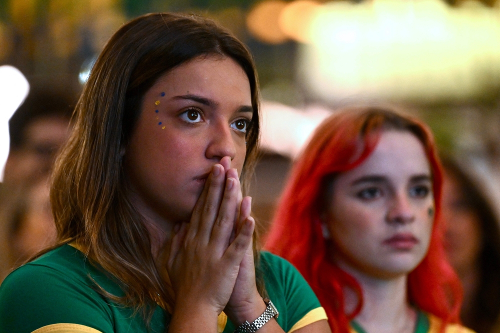 Brazilian fans watch the live broadcast the match at a bar in Brasilia. — AFP