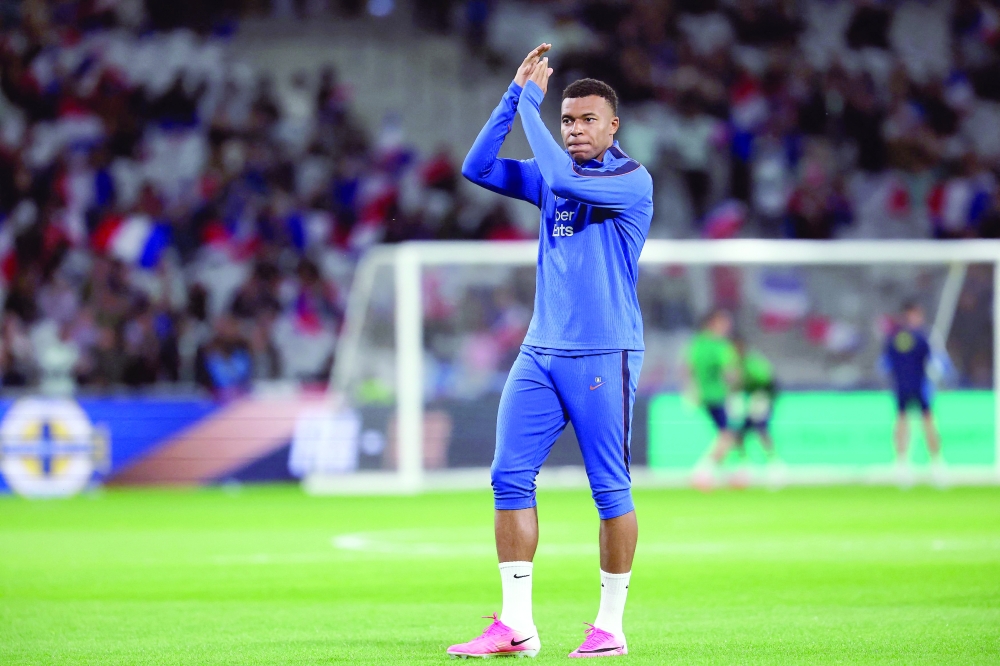 France's forward #10 Kylian Mbappe warms up. — AFP