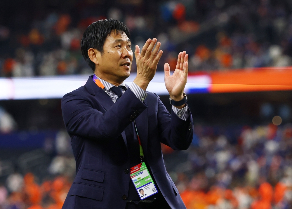  
Japan coach Hajime Moriyasu applauds their fans as he leaves the pitch after the match REUTERS 