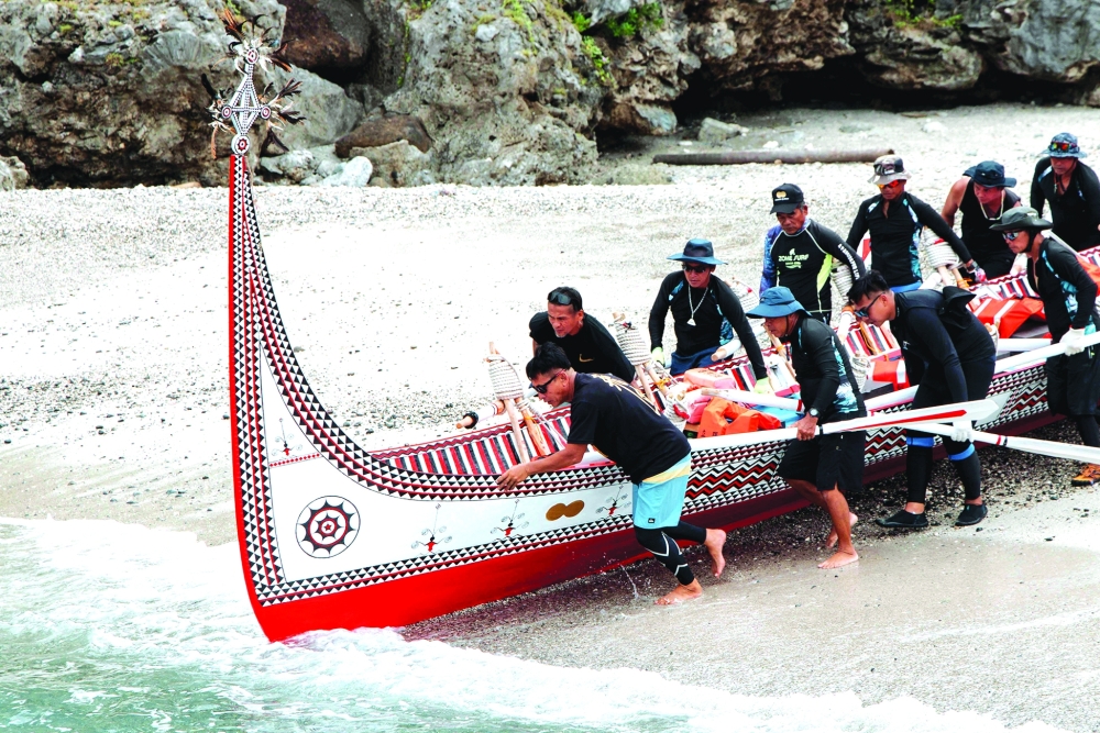 The Tao (Yami) indigenous rowers launch a traditional wooden canoe called Ovayan (Golden Friendship) for its voyage to Philippines' Batanes Islands. -AFP
