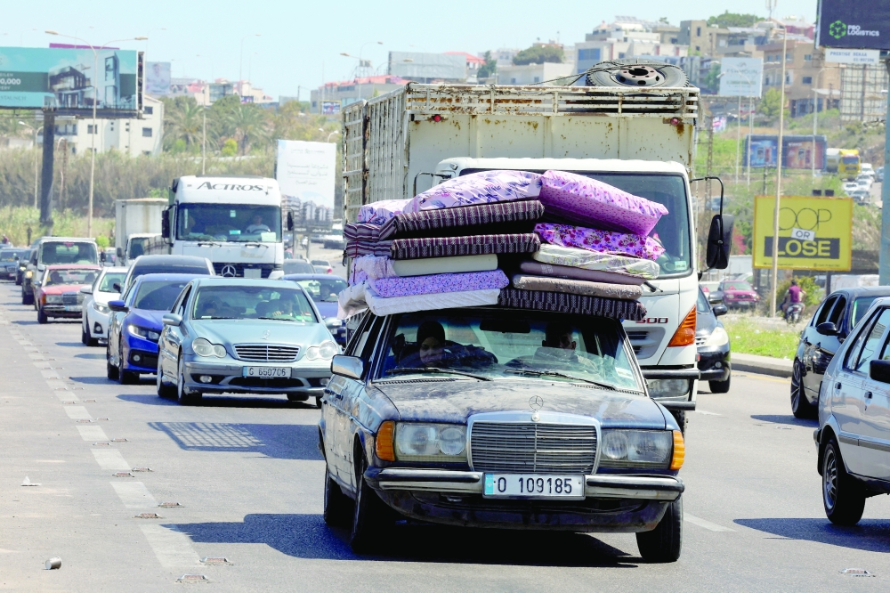 Displaced people make their way back to their homes in southern Lebanon. — Reuters 