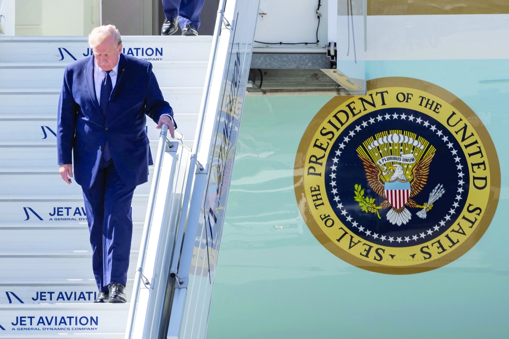 US President Donald Trump disembarks Air Force One after landing at the Geneva airport. — AFP