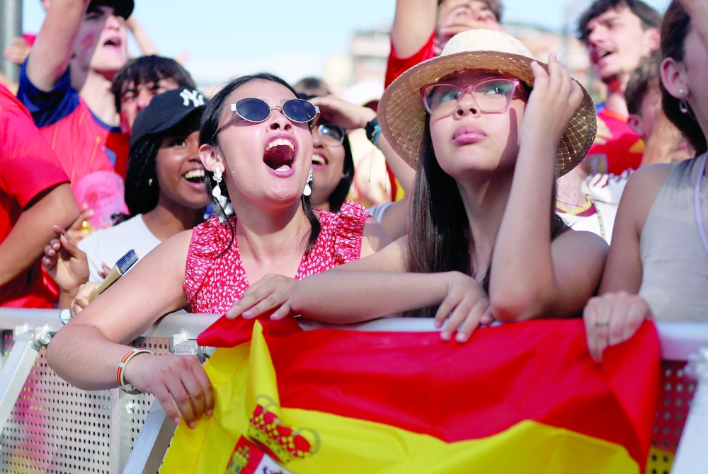 Spain fans react as they watch the match. — REUTERS