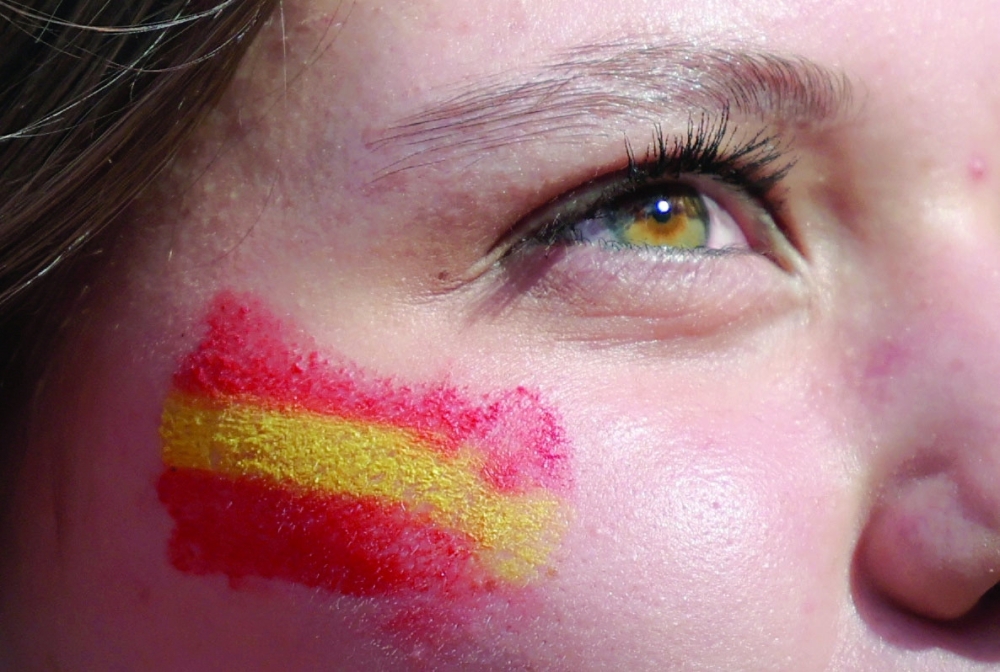 A Spain fan has the flag painted on her face before the match. —  REUTERS