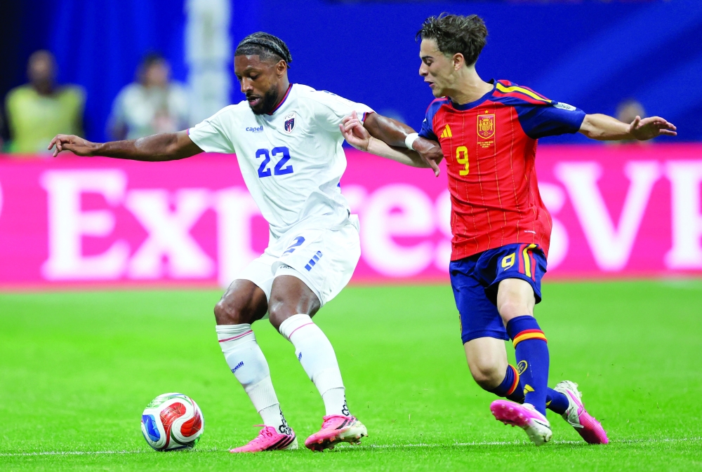 Cape Verde's Steven Moreira in action with Spain's Gavi. — Reuters