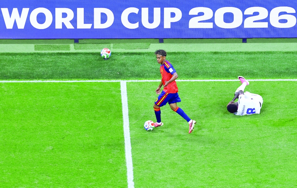 Spain's Lamine Yamal in action as Cape Verde's Joao Paulo lies on the pitch. — REUTERS