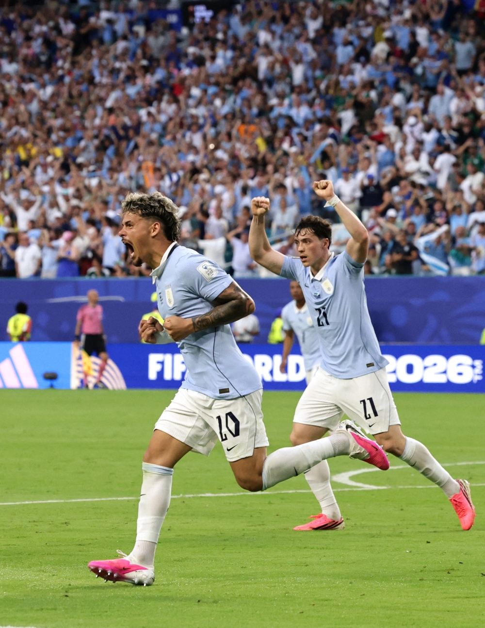  
Uruguay's Maxi Araujo celebrates scoring their first goal with Federico Vinas  