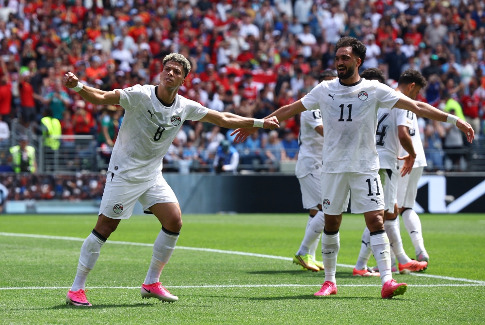  
Egypt's Emam Ashour celebrates scoring their first goal with Mostafa Zico. — Reuters