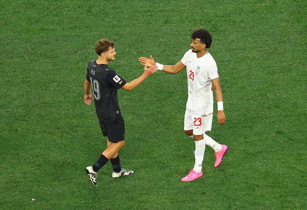 
New Zealand's Ben Old Just shakes hands with Iran's Ramin Rezaeian  