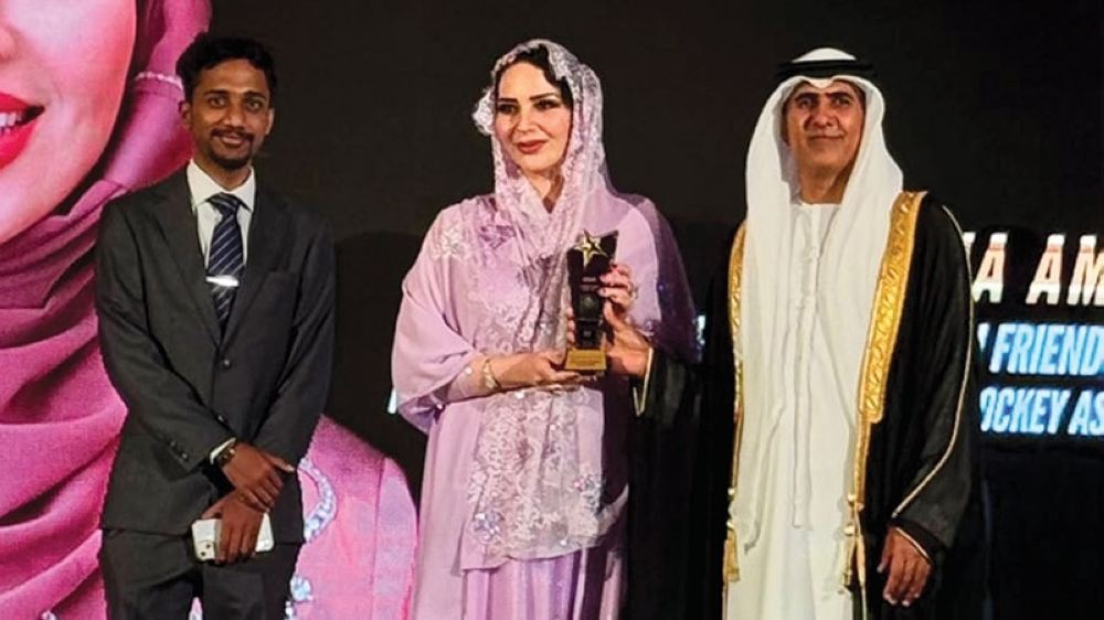 Rudaina bint Amer al Hajri receives the award in Dubai.
