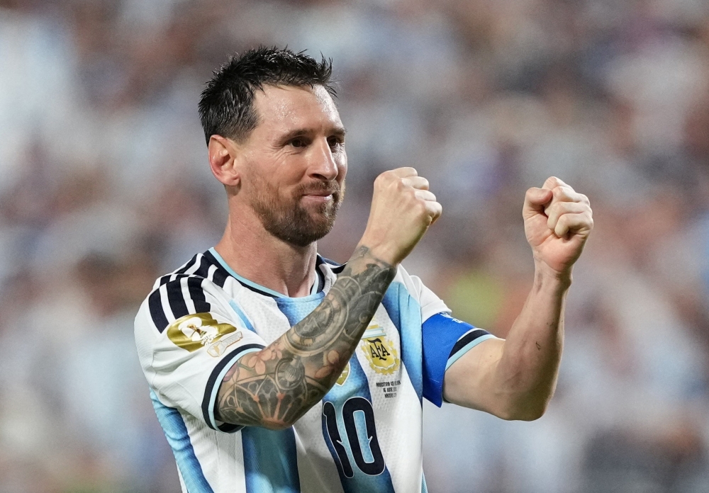  
Argentina's Lionel Messi celebrates scoring their third goal to complete a hat-trick 