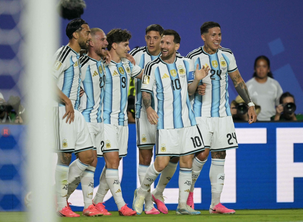 Argentina's forward #10 Lionel Messi celebrates with teammates scoring his team's second goal  