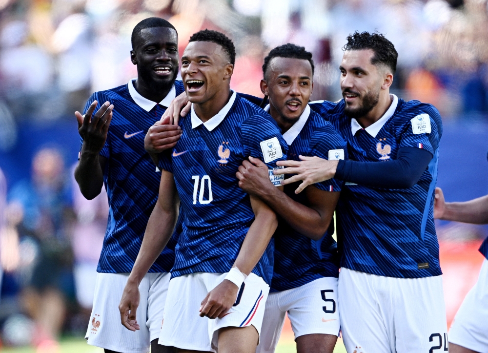 France's Kylian Mbappe celebrates scoring their third goal with Dayot Upamecano, Jules Kounde and Rayan Cherki 