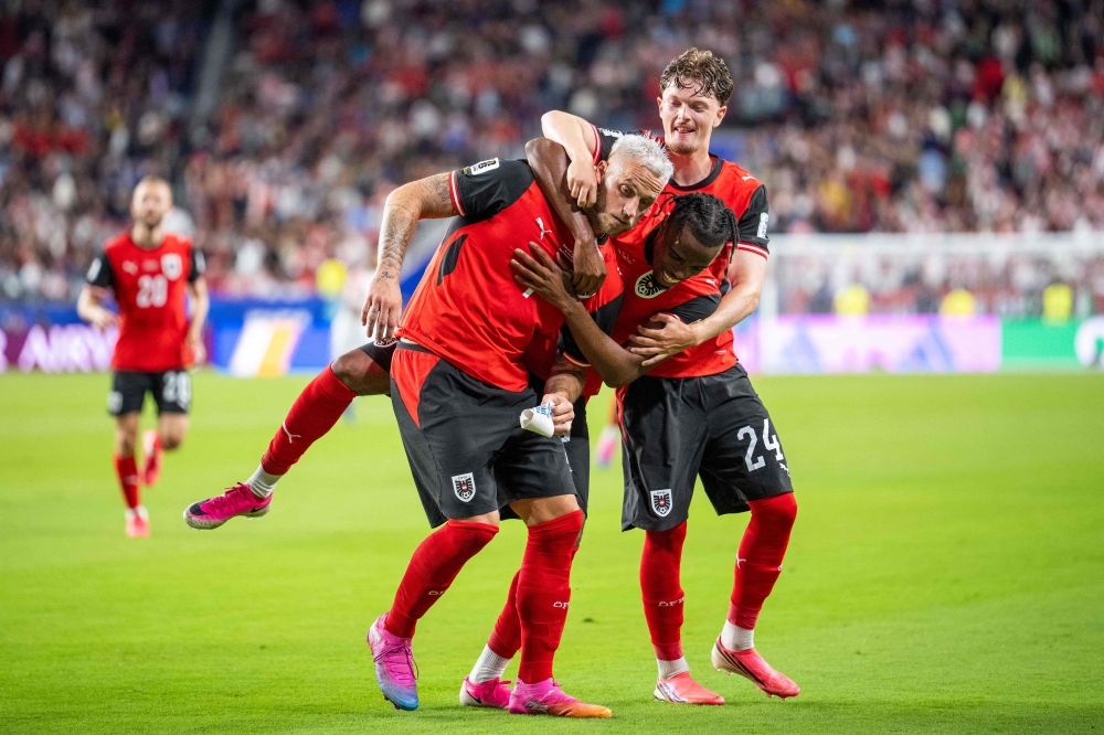 Austria's forward #07 Marko Arnautovic (L), celebrate with  Austria's midfielder #17 Carney Chukwuemeka and Austria's midfielder #24 Paul Wanner after scoring a penalty shot 