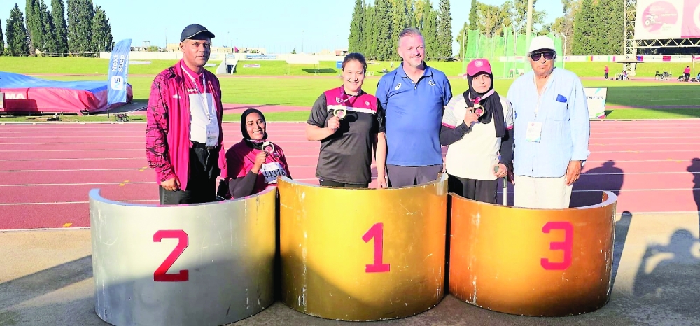 Eman bint Taysir al Shamsi celebrates on the podium after winning silver in the women’s javelin.