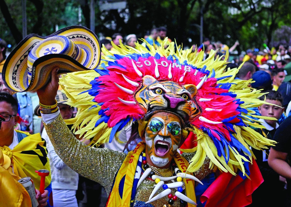 Colombia’s fans support their team at the Angel of Independence monument in Mexico City. — AFP