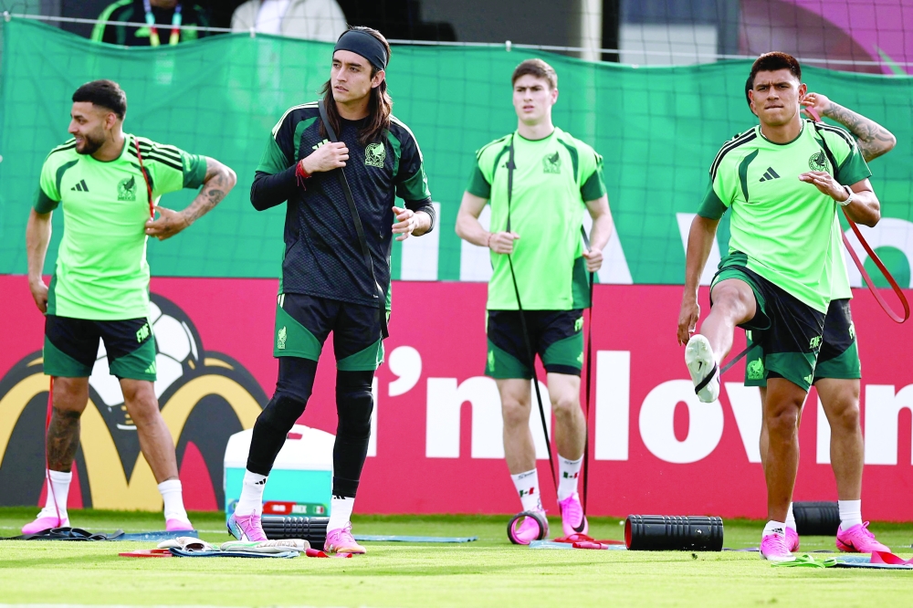 Mexico's goalkeeper Carlos Acevedo and Mexico's defender Jesus Gallardo take part in a training session at Sports Arena in Zapopan. — AFP