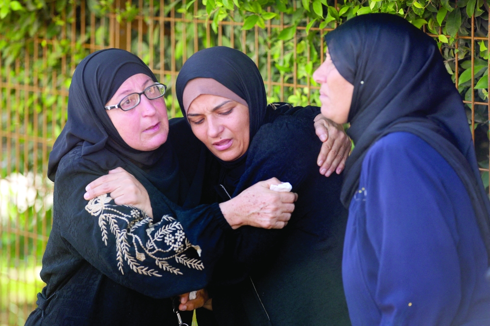 Mourners react during the funeral of Palestinians, in Khan Yunis. — Reuters