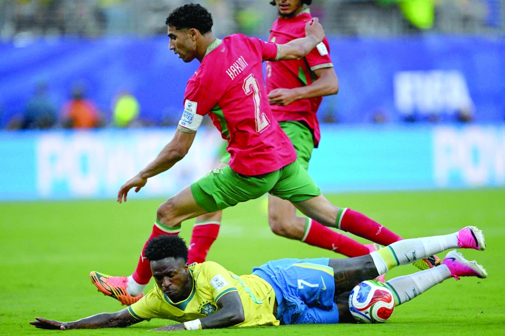 Morocco's defender #02 Achraf Hakimi and Brazil's forward #07 Vinicius Junior fight for the ball during the 2026 World Cup Group C football match between Brazil and Morocco at the New York/New Jersey Stadium. — AFP