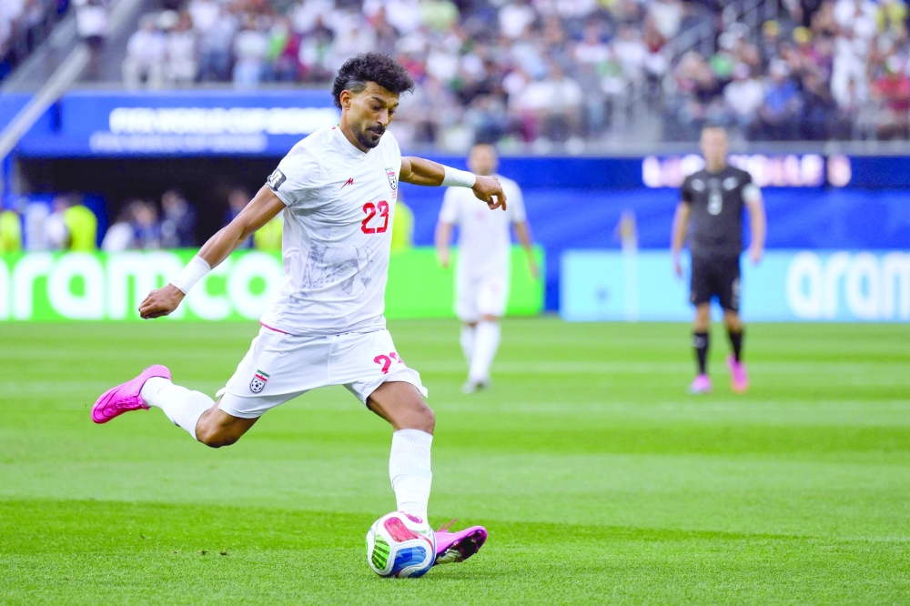 Iran's defender Ramin Rezaeian kicks the ball during the 2026 World Cup Group G football match between Iran and New Zealand