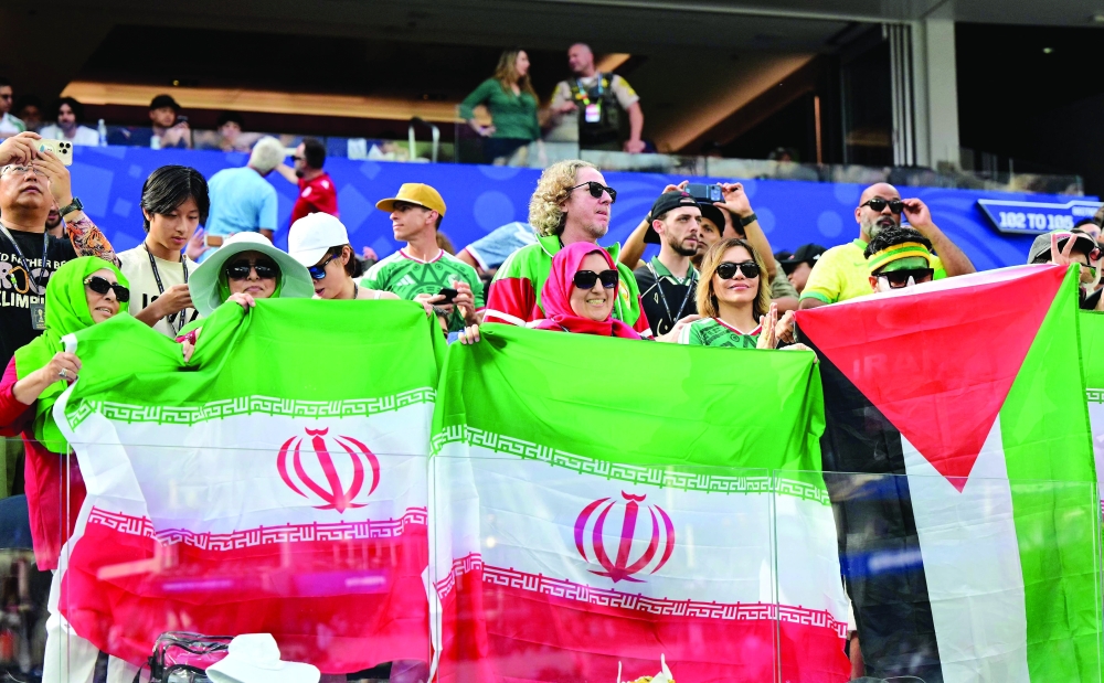 Iranian fans show a Palestinian flag among Iranian flags ahead of the 2026 World Cup Group G football match between Iran and New Zealand 