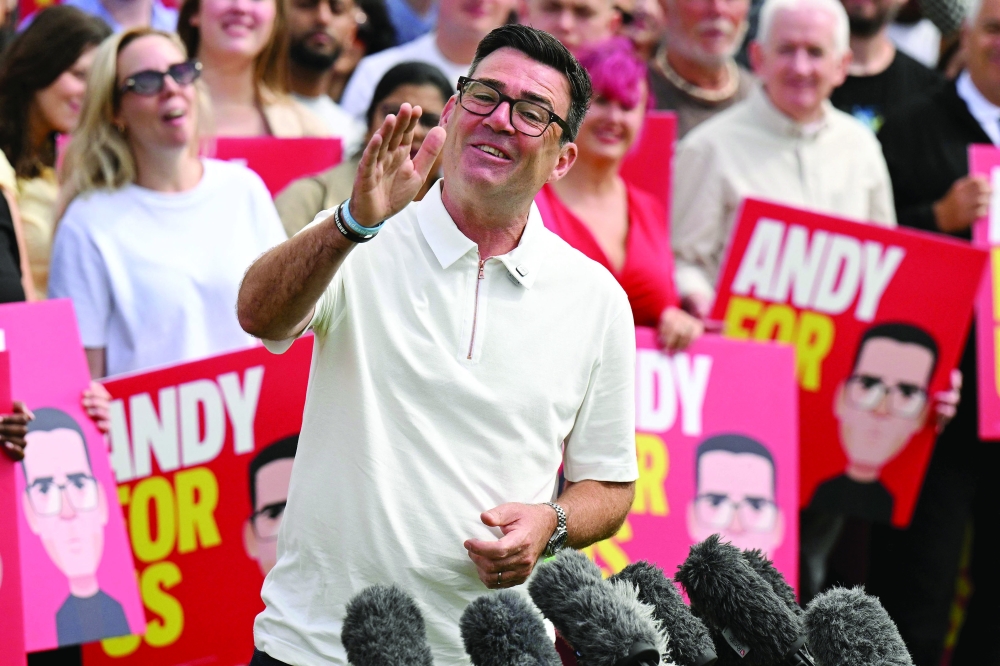Andy Burnham speaks to supporters and members of the media, the morning after his by-election victory, at Ashton Town FC