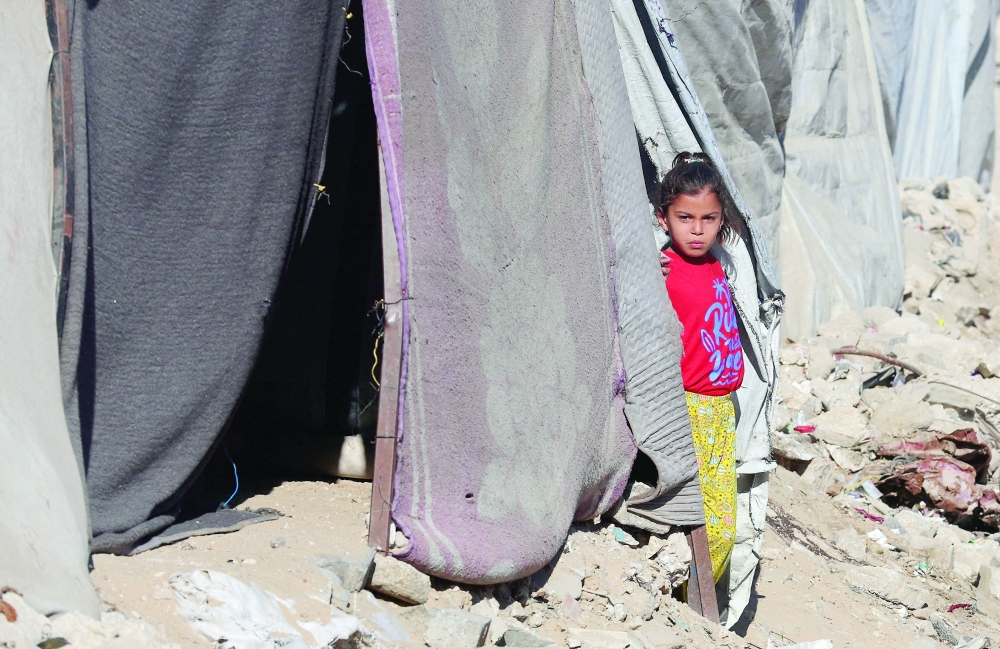 A displaced Palestinian child shelters at a tent camp, in Khan Yunis in the southern Gaza Strip