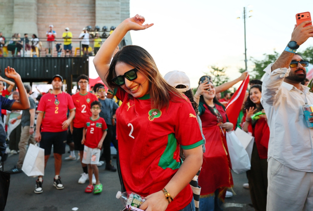  
A Morocco fan celebrates after the match at the Brooklyn Bridge park watch part 
